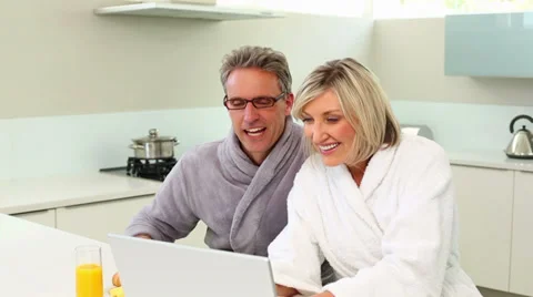 Couple using their laptop at breakfast time Stock Footage 34681510