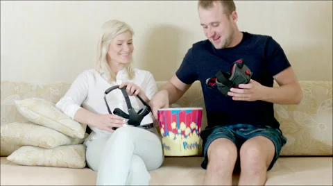 Couple using VR glasses sitting on the sofa Stock Footage 62730039