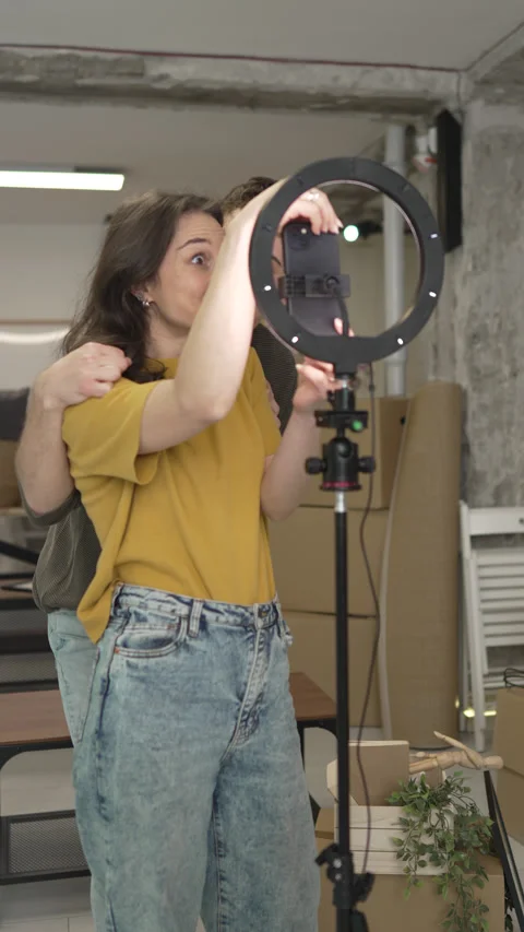 Couple v-loggers use mobile phone and ring light for record video Video stock 309002435