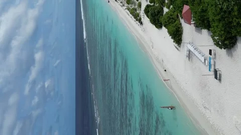 Couple on vacation taking photos at beach swing on Dhigurah Island, 動画素材 242500820