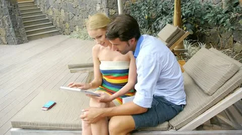Couple on vacation using electronic tablet Stock Footage 14827803