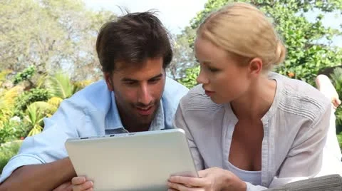 Couple in vacation using electronic tablet Stock Footage 18194994