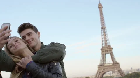 Couple visiting the Eiffel tower and taking selfies with each other. Stock Footage 63032068