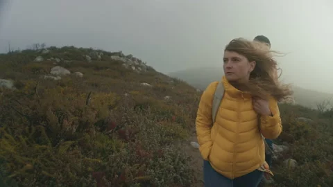 Couple walk on dramatic hike at sunrise in field Stock Footage 150206017