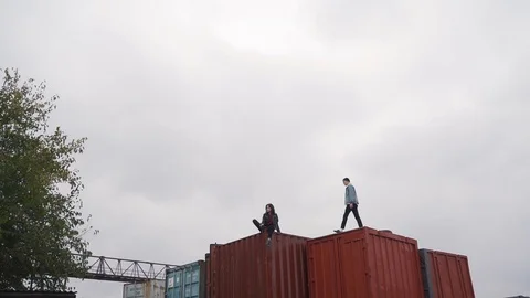 Couple walk on a freight container Stock Footage 91773390