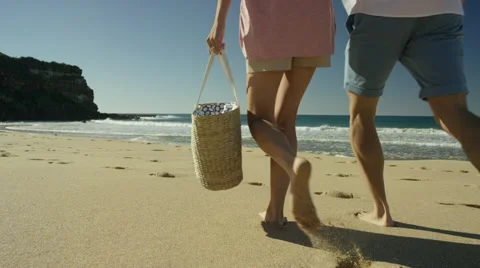 Couple Walking Across  Sandy Beach on summers Day, Steadycam Gimbal Stock Footage 63605873