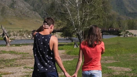 Couple walking against the backdrop of the mountains. Honeymoon. man and woman Stock-Footage 105567857