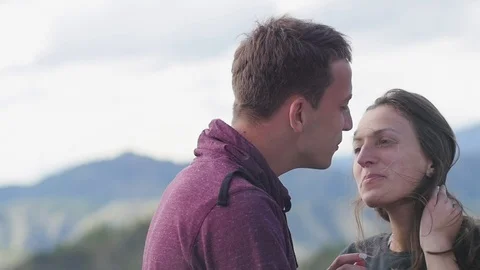 Couple walking against the backdrop of the mountains. Honeymoon. kiss on the Stock Footage 105568370