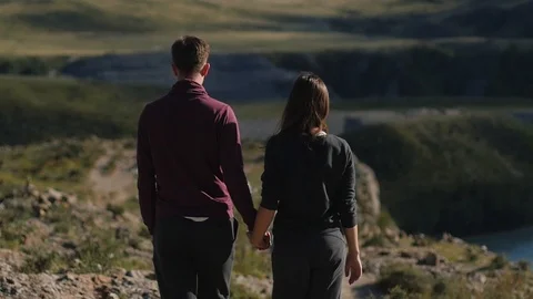 Couple walking against the backdrop of the mountains. Honeymoon. man and woman Vídeos de archivo 105568440