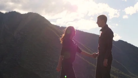 Couple walking against the backdrop of the mountains. Honeymoon. kiss on the Stock Footage 105983362