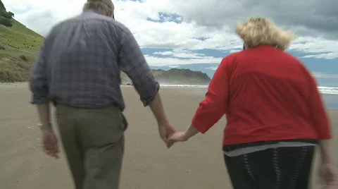 Couple walking along the beach Stock Footage 553384