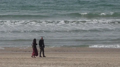 A couple walking along the beach Stock Footage 100605056