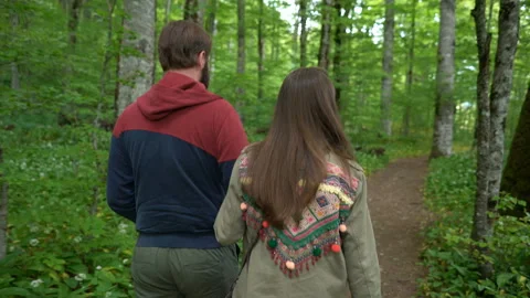 Couple walking along a forest path Stock Footage 109333931