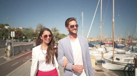 Couple walking along harbor Stock Footage 62708060