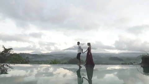 Couple Walking Along Infinity Pool in Bali Stock Footage 106062725