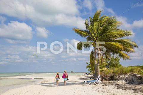 Couple walking along Playa El Paso, Cayo Guillermo, Jardines del Rey, Ciego de Stock Photos
