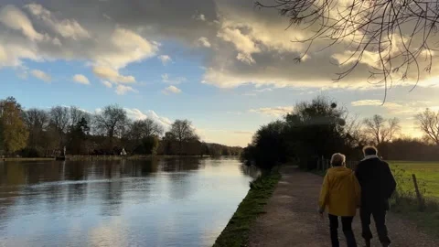 Couple walking along a river Stock Footage