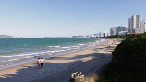 Couple walking along a sandy beach in nha trang, vietnam Stock Footage 338338277