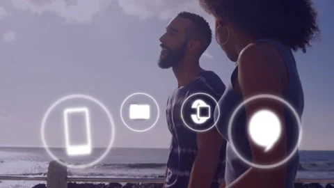 Couple walking along shore as tech UI icons appearing, overlapping pair, Stock Footage 333837896