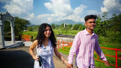 Couple walking and talking through garden path Stock Footage 301439510
