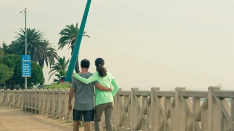 Couple walking arms around each other Santa Monica, Los Angeles, California 스톡 동영상 45367586
