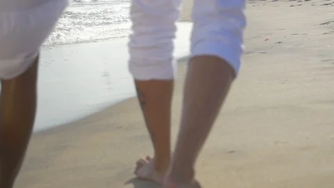 Couple walking on the beach 2 Stock Footage 128074911