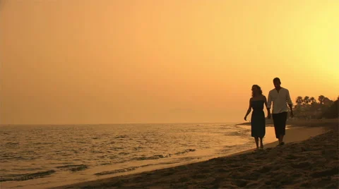 Couple walking on beach at dusk. Stock Footage 43654650