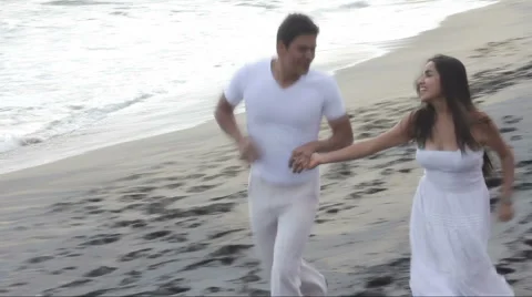 Couple walking on the beach Stock Footage 1092448