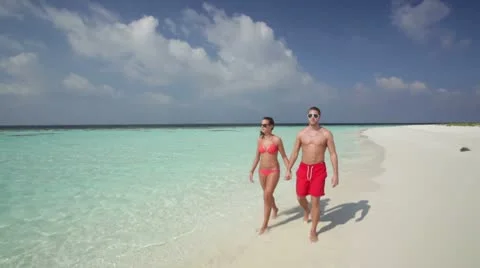 Couple walking on beach Stock Footage 10788279