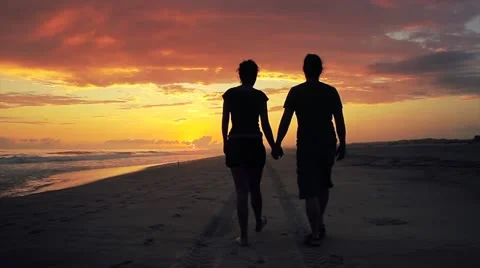 Couple walking on beach Stock Footage