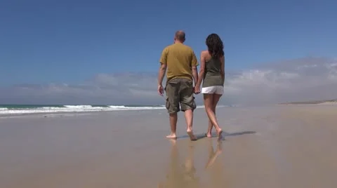 Couple walking the beach Stock Footage 21224311