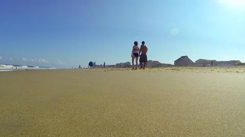A Couple Walking on the Beach Stock Footage 58823831