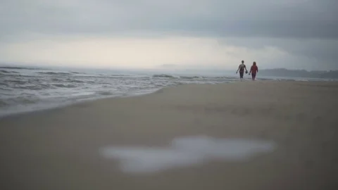 Couple walking on the beach Stock Footage