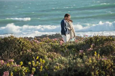 Couple walking on the beach Stock Photos