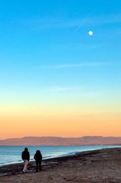 Couple walking on the beach Stock Photos