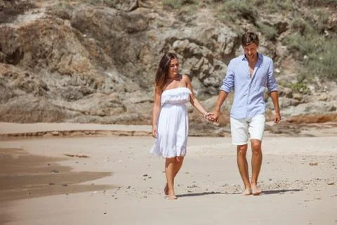 Couple walking on beach Stock Photos