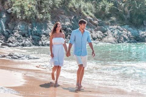 Couple walking on beach Stock Photos