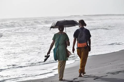 Couple walking at beach Stock Photos