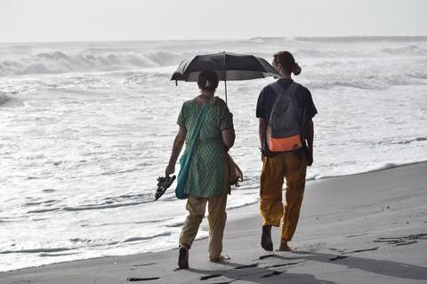 Couple walking at beach Stock Photos