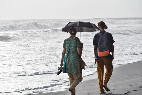 Couple walking at beach Stock Photos
