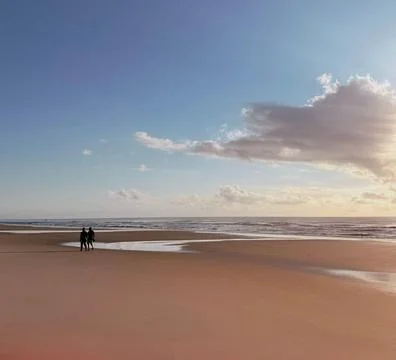 Couple walking on the beach Stock Photos