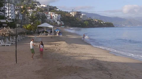 Couple Walking on Beach seen from the Malecon (Broadwalk)Puerto Vallarta, Mexico Video stock 50116320