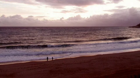 Couple walking on the beach at sunset Stock Footage 644650