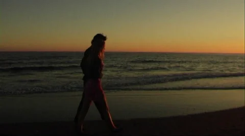 Couple walking on beach at sunset Stock Footage 43689315