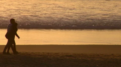 Couple walking on beach at sunset Stock Footage 48671809