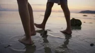Couple Walking On Beach At Sunset Stock Footage