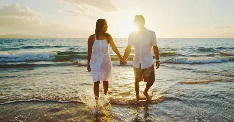 Couple Walking on the Beach at Sunset Stock Footage 81910260