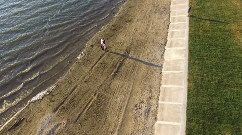 Couple walking on the beach at sunset. Shooting with quadrocopters. Dron. dji Stock Footage 67485900