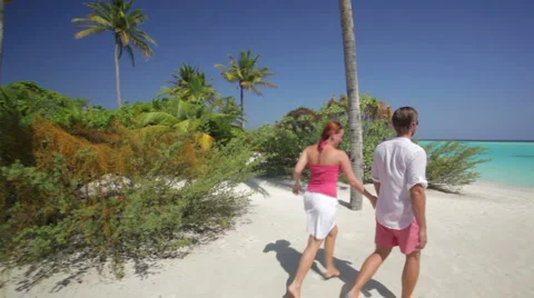 Couple walking to the beach together Stock Footage 1009198