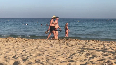 Couple Walking at the beach vs Beautiful Girls Making Pictures Stock Footage 91496584